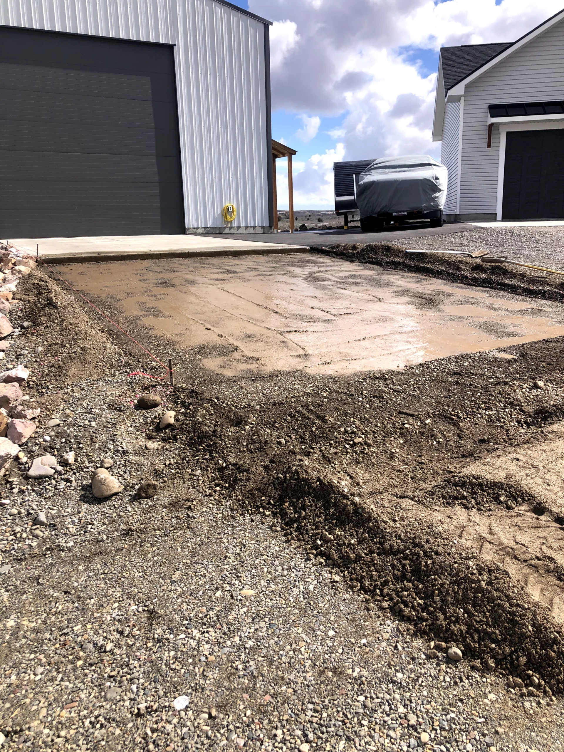 Freshly cleared concrete pad in Eastern Idaho showing removal and excavation work before new foundation installation.