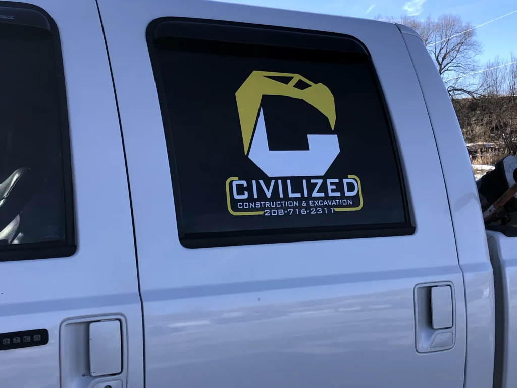 A white truck displaying the word "civilized" prominently on its side.
